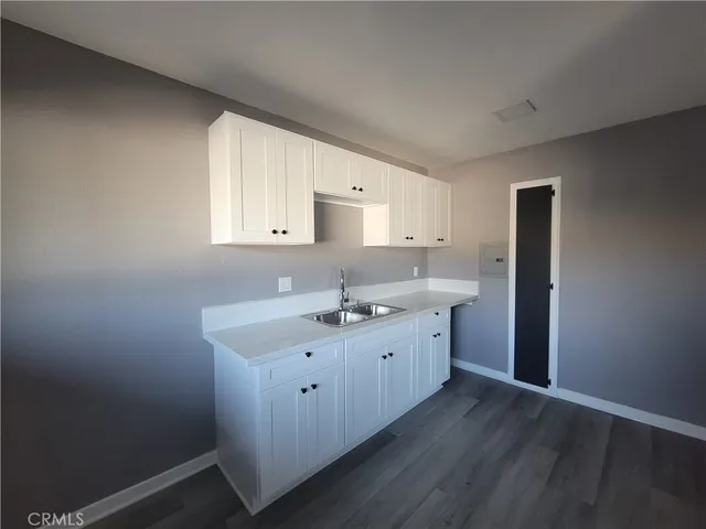 a kitchen with sink and cabinets
