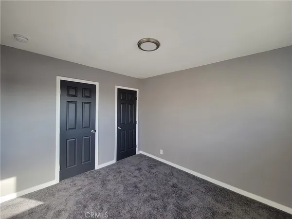an empty room with closet area
