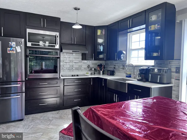 a kitchen with a refrigerator stove and sink