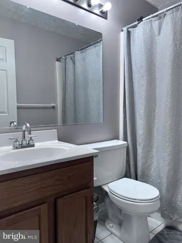 a bathroom with a sink vanity mirror and toilet