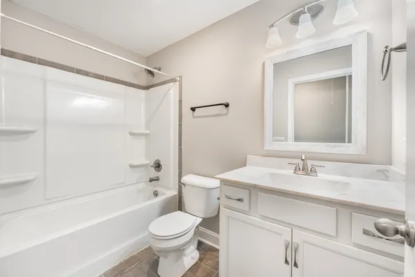 a bathroom with a sink a toilet a mirror a vanity a shower and vanity