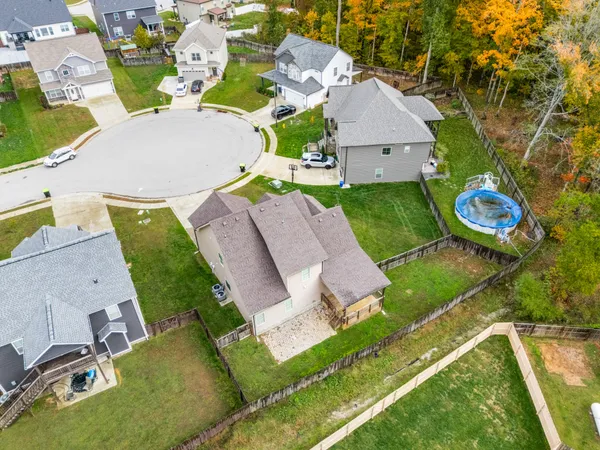 an aerial view of a house with garden space and street view