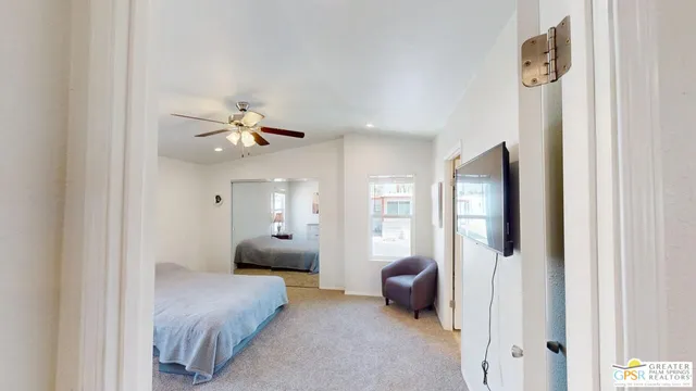 a bedroom with a bed couch and window