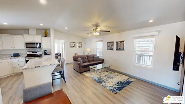 a living room with furniture kitchen and a window