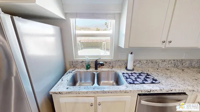 a kitchen with a sink a stove and refrigerator