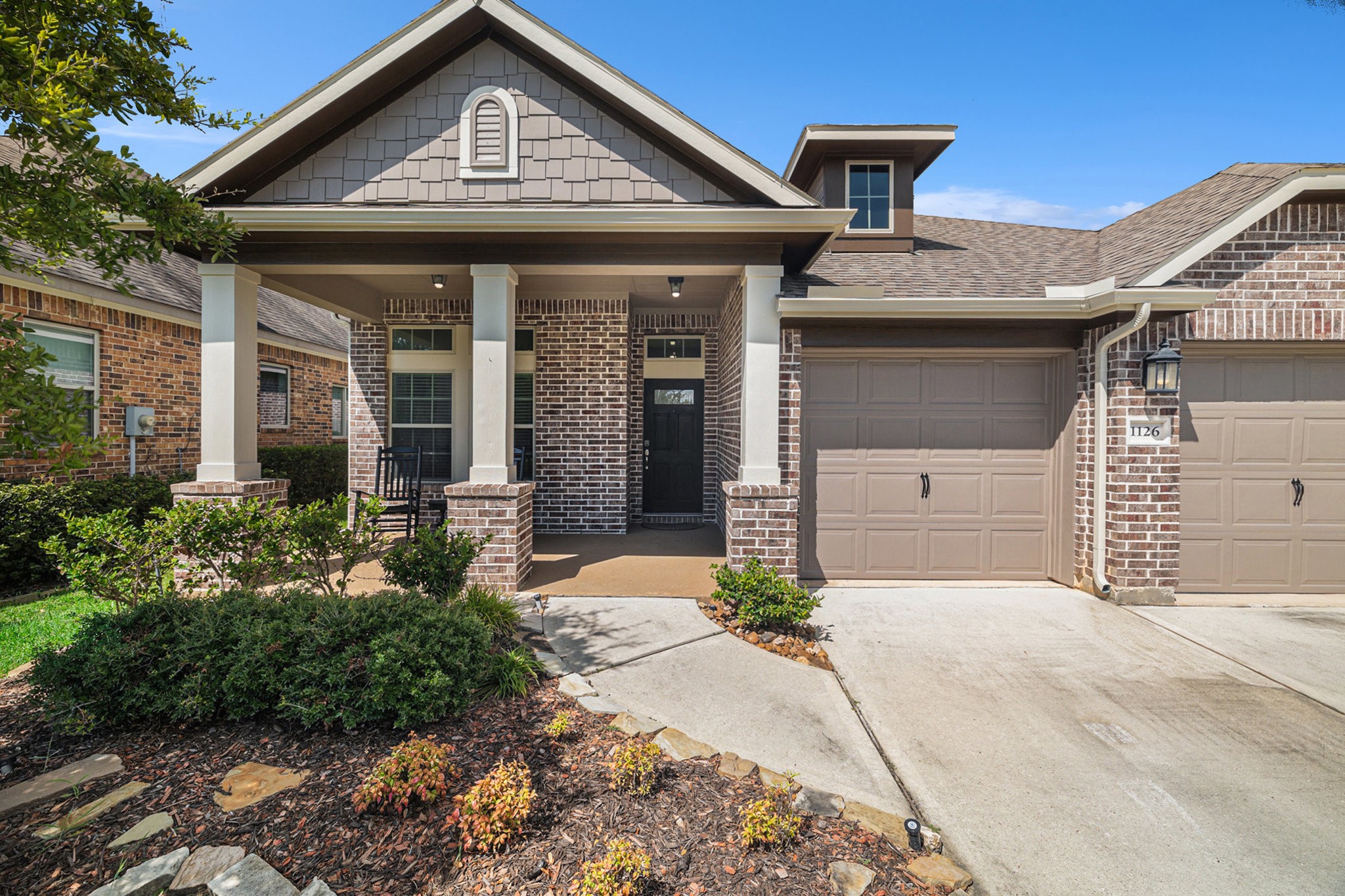 1126 Audrey Trail Tomball, TX 77375 - Photo 2 of 35 a front view of a house with a yard and garage