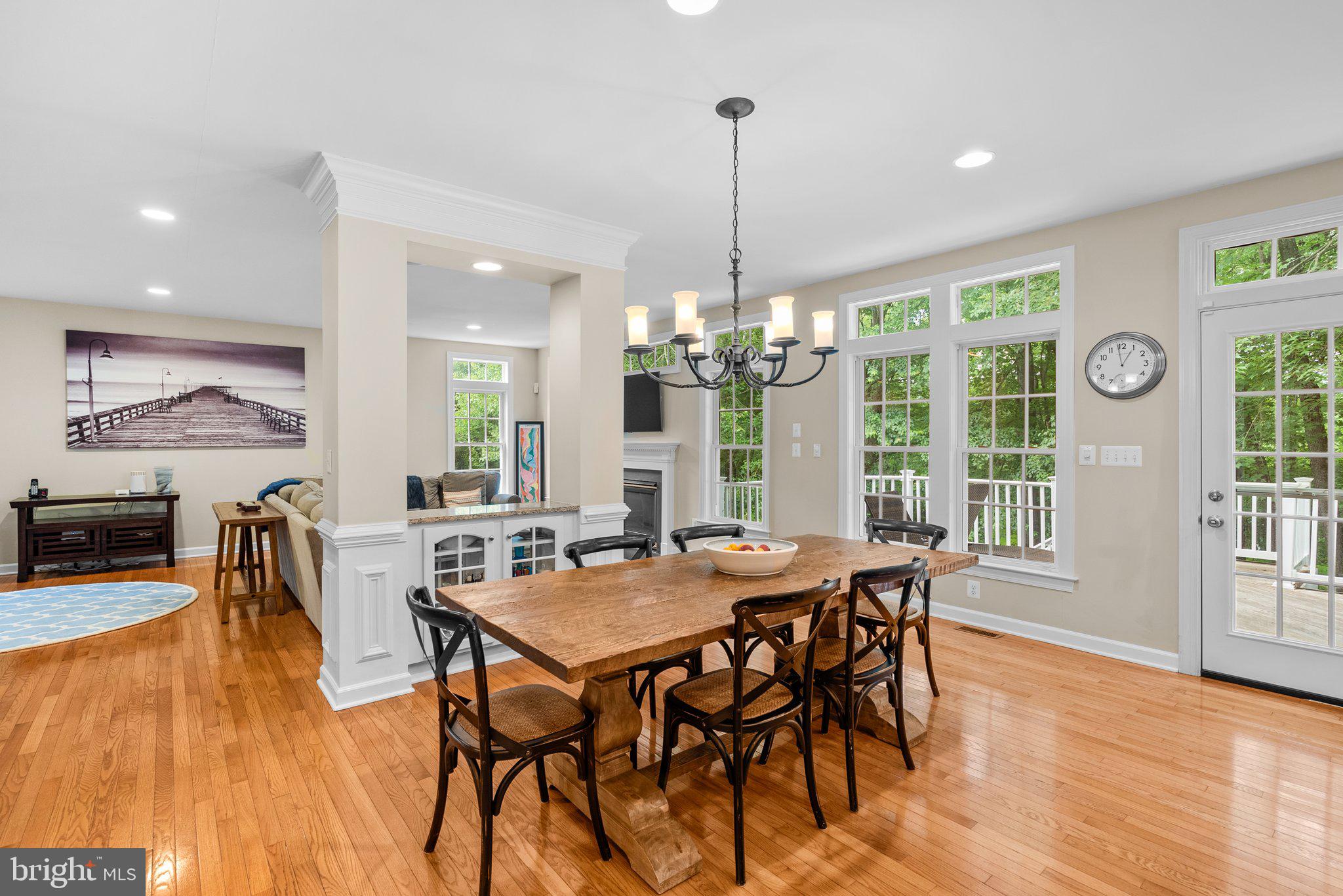 869 Still Creek Lane Gaithersburg, MD 20878 - Photo 12 of 58 a view of a dining room and livingroom with furniture wooden floor a chandelier
