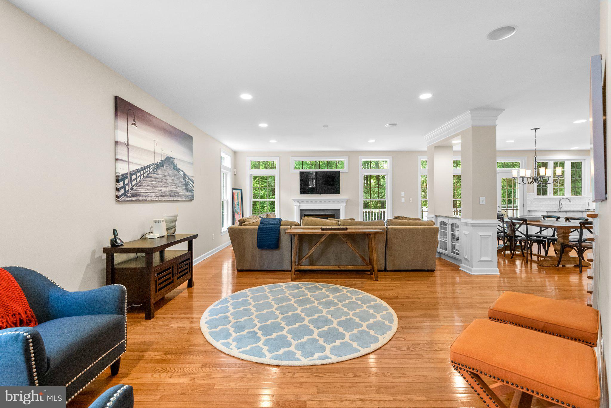 869 Still Creek Lane Gaithersburg, MD 20878 - Photo 15 of 58 a living room with furniture a dining table and a fireplace