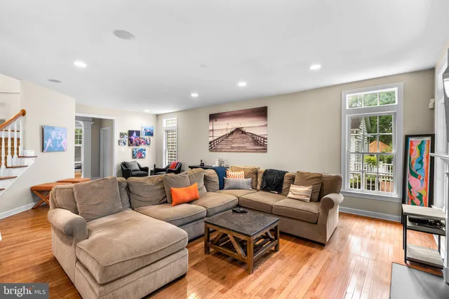 a living room with fireplace furniture and a book shelf