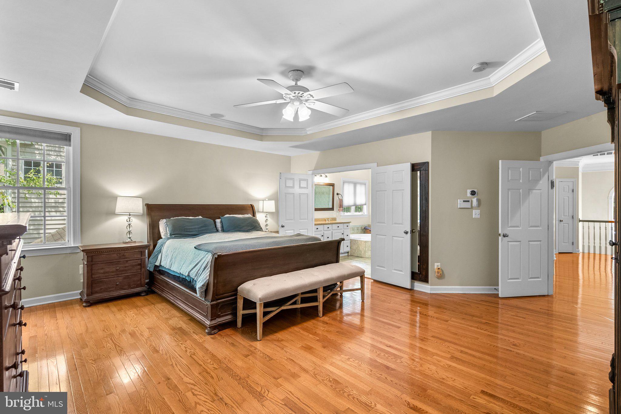 869 Still Creek Lane Gaithersburg, MD 20878 - Photo 23 of 58 a spacious bedroom with a bed and a table chair
