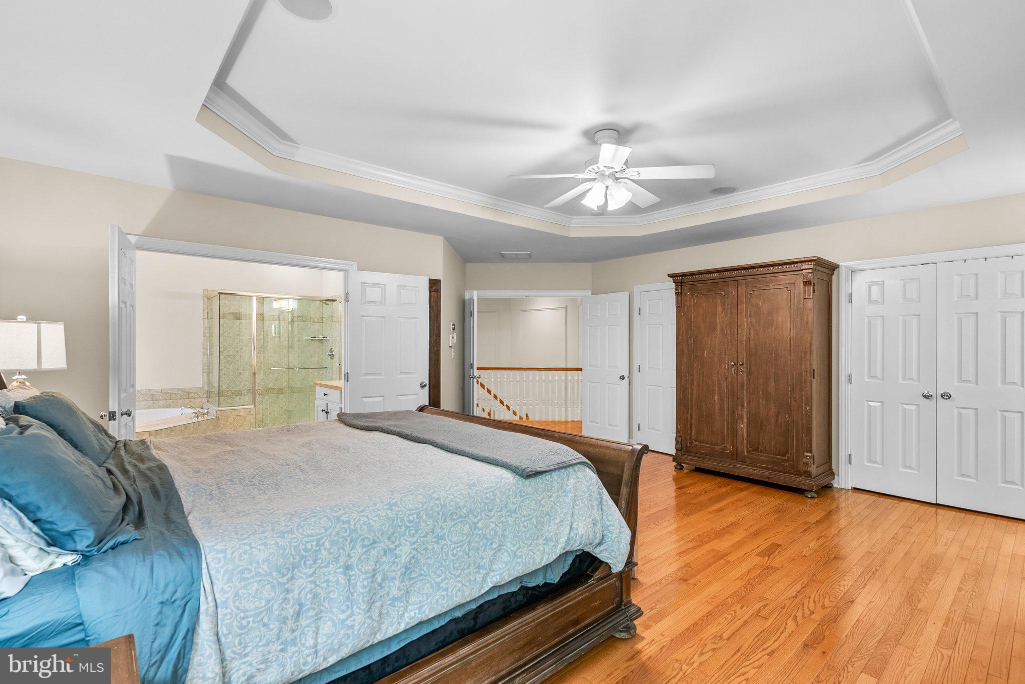 869 Still Creek Lane Gaithersburg, MD 20878 - Photo 24 of 58 a spacious bedroom with a bed and a chandelier