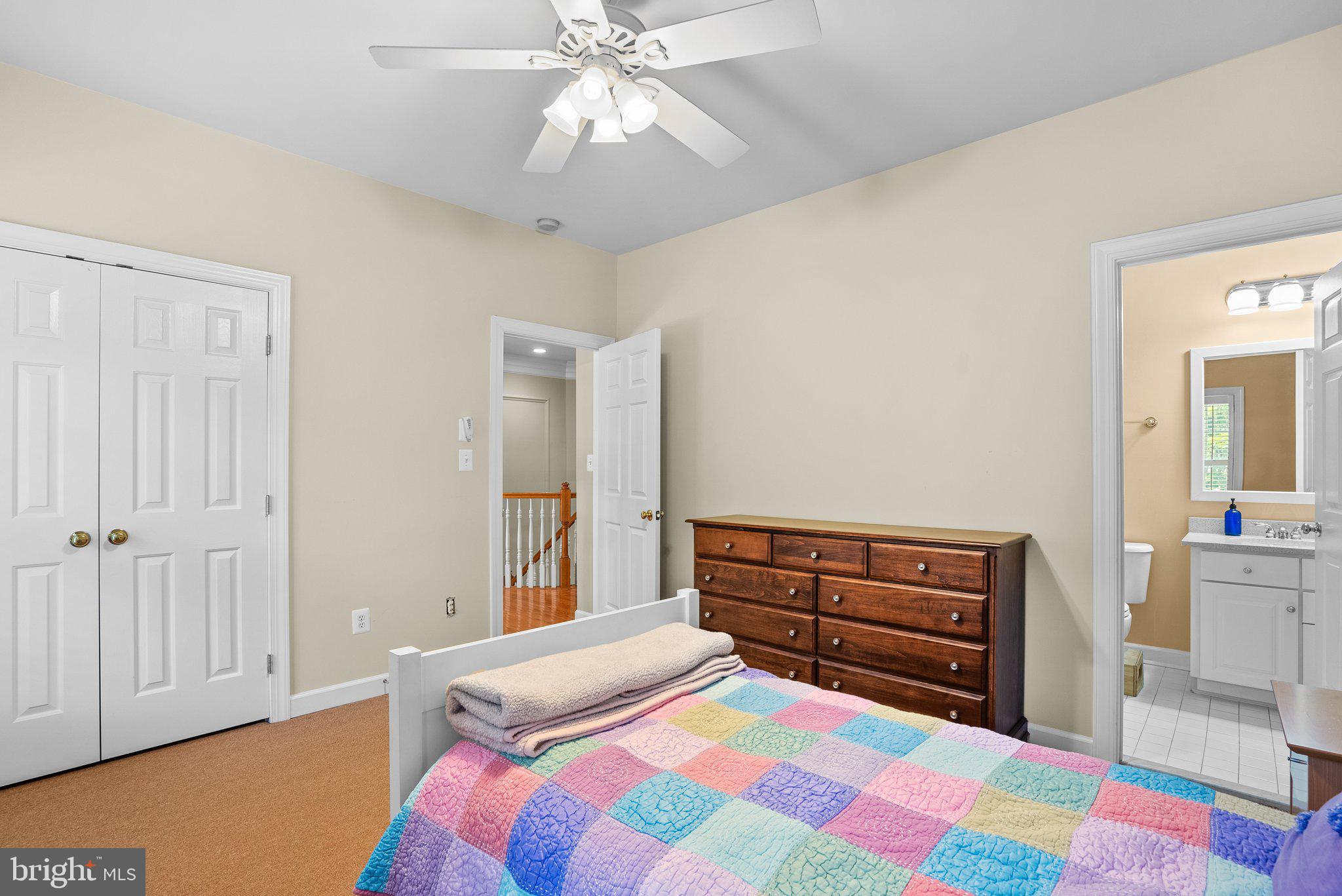869 Still Creek Lane Gaithersburg, MD 20878 - Photo 28 of 58 a bedroom with a bed and a chandelier