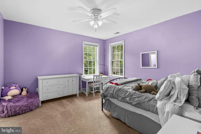 a bedroom with furniture and a chandelier