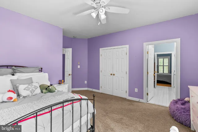 a en suite bathroom with a granite countertop sink and a mirror