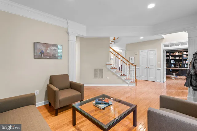 a living room with furniture and a book shelf