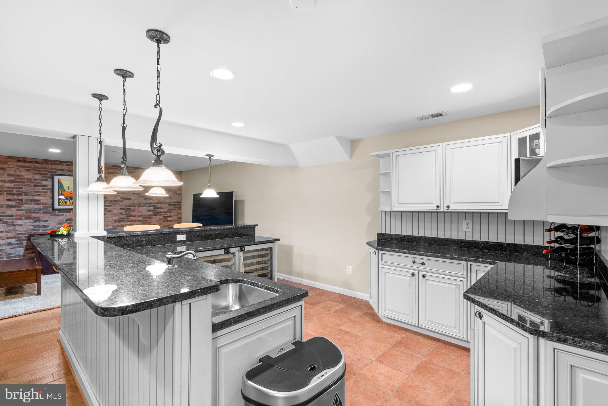 869 Still Creek Lane Gaithersburg, MD 20878 - Photo 42 of 58 a kitchen with stainless steel appliances granite countertop a sink stove and cabinets