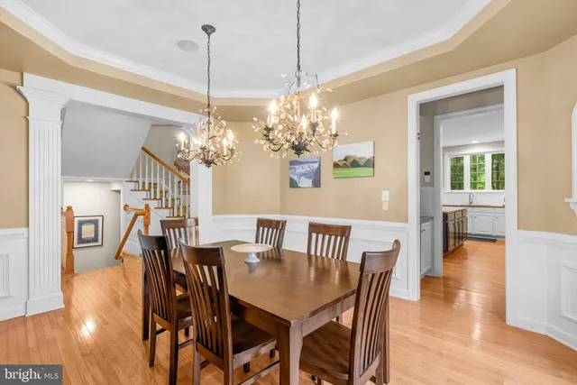 a view of a dining room with furniture wooden floor and chandelier