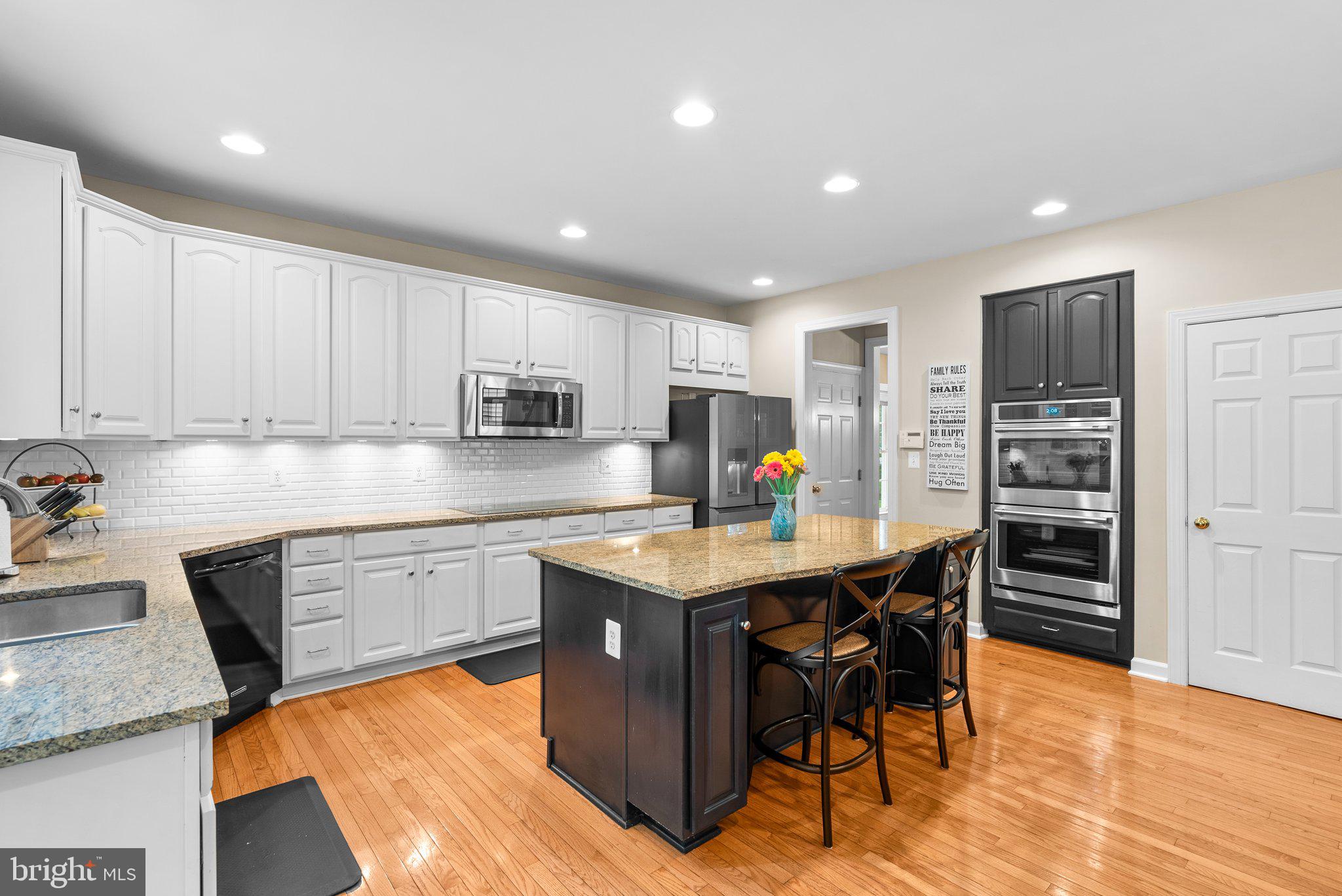869 Still Creek Lane Gaithersburg, MD 20878 - Photo 9 of 58 a kitchen with stainless steel appliances granite countertop a table chairs sink refrigerator and cabinets