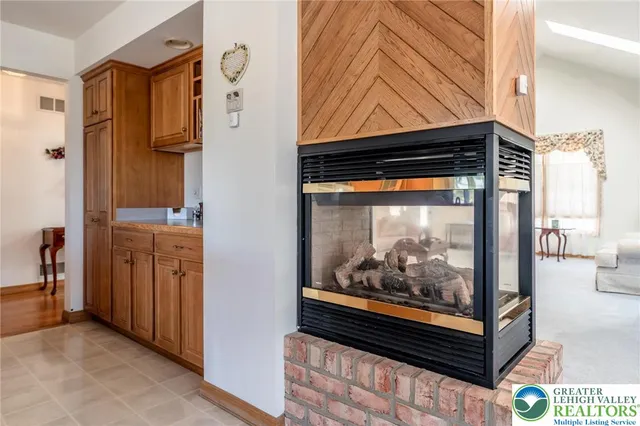 a kitchen with refrigerator a sink and chairs