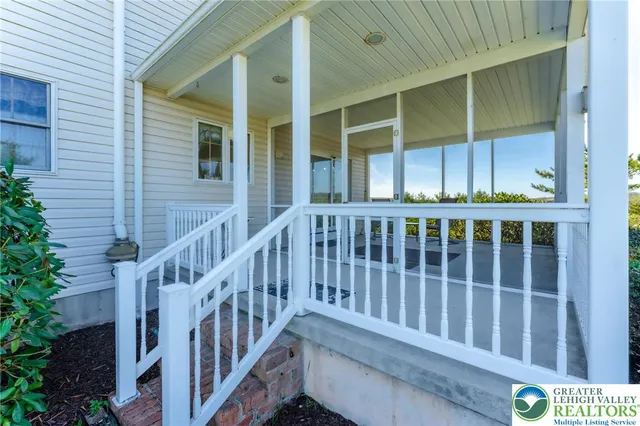 a view of a porch with chairs and potted plants