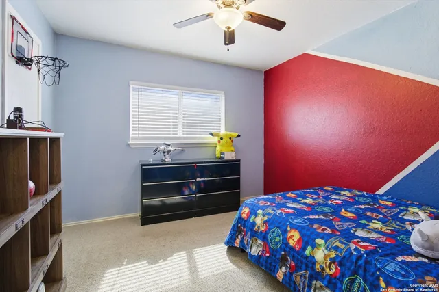 a bedroom with a bed and a book shelf