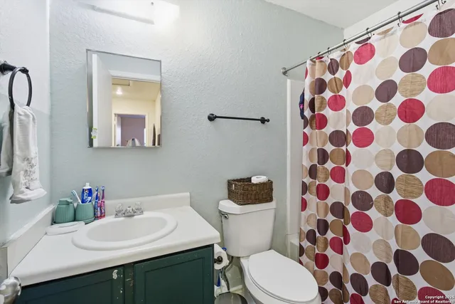 a bathroom with a sink a toilet and a mirror