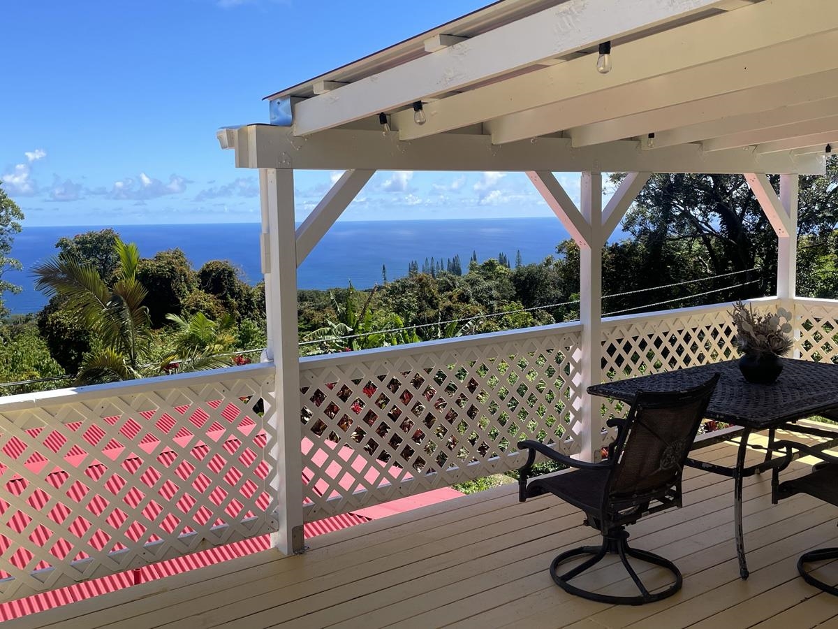 979 Hana Highway Haiku, HI 96708 - Photo 14 of 25 a view of a chairs and table in patio with a wooden fence