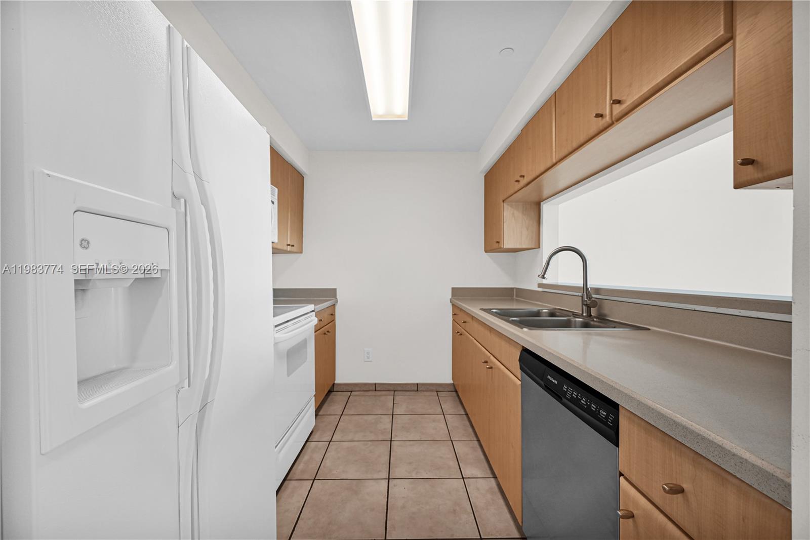 2475 Brickell Avenue, Unit 703 Miami, FL 33129 - Photo 13 of 30 a kitchen with a sink and refrigerator