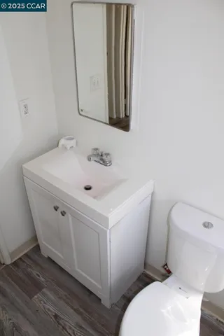 a white toilet sitting next to a bathroom sink