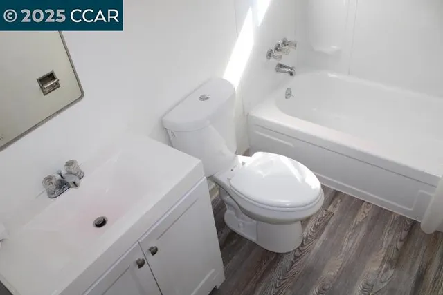 a bathroom with a sink a toilet and bathtub