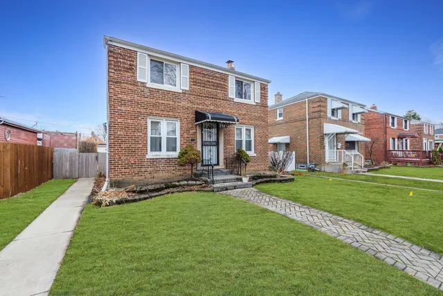 a front view of a house with a yard table and chairs