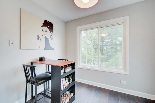 a kitchen with stainless steel appliances a stove a sink dishwasher a refrigerator and a dining table with wooden floor