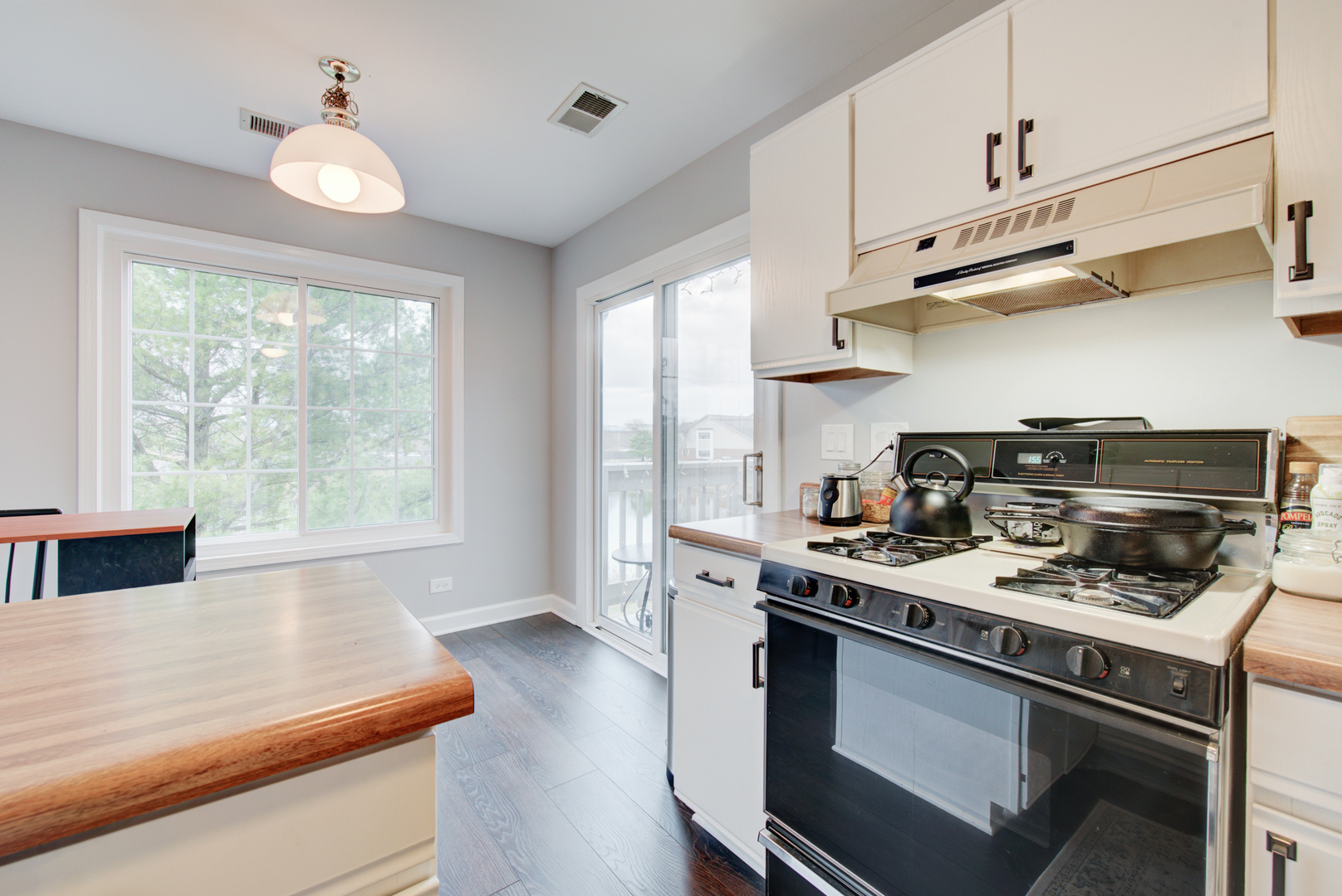 2458 Charleston Drive, Unit 6 Schaumburg, IL 60193 - Photo 18 of 31 a kitchen with stainless steel appliances a stove a sink dishwasher a refrigerator and a dining table with wooden floor