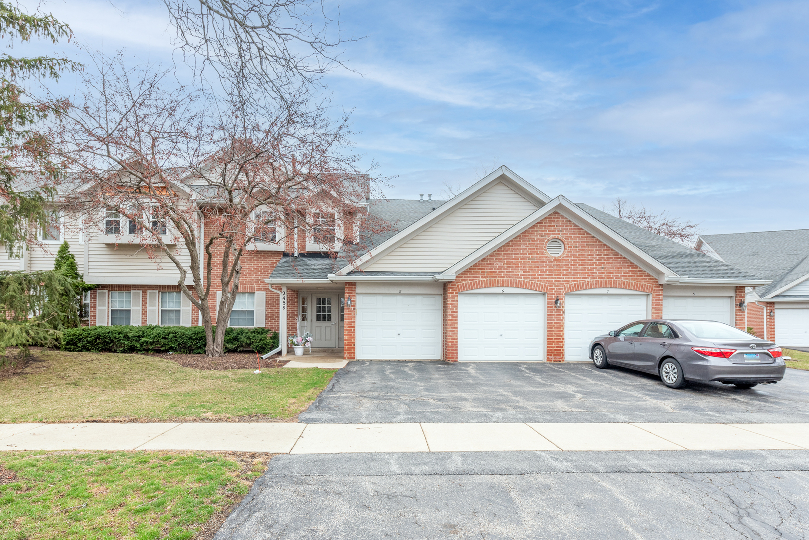 2458 Charleston Drive, Unit 6 Schaumburg, IL 60193 - Photo 2 of 31 a front view of a house with a yard