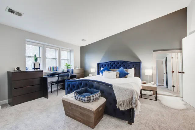 a living room with furniture and a bed