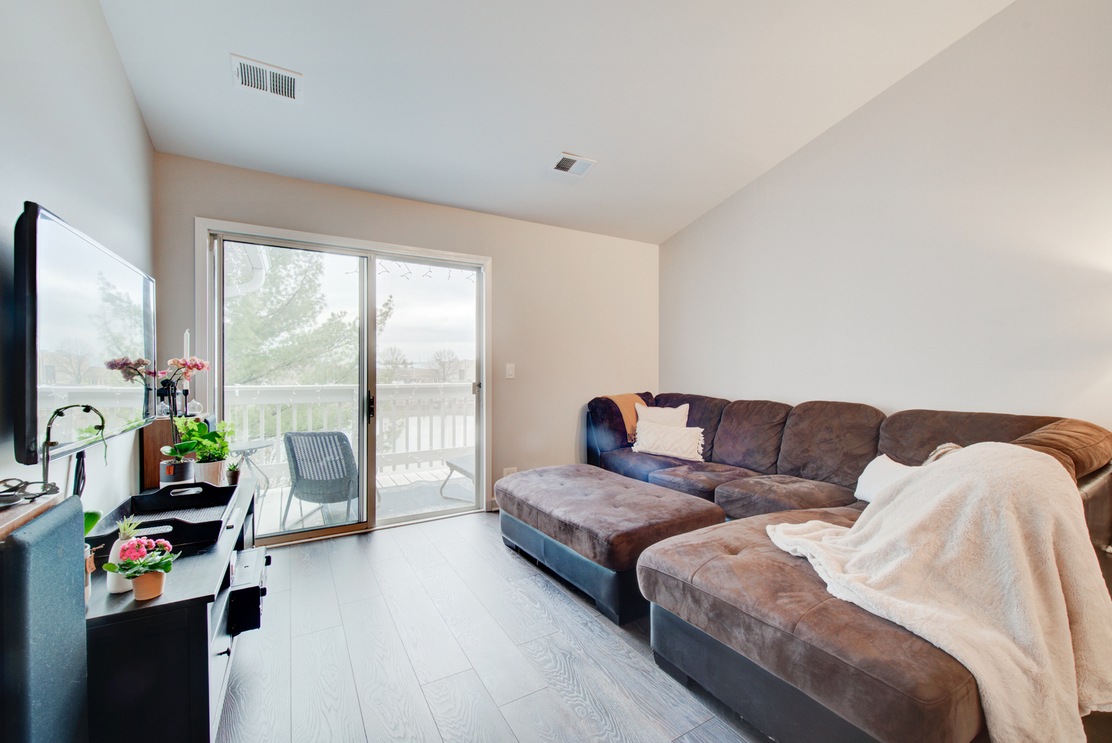 2458 Charleston Drive, Unit 6 Schaumburg, IL 60193 - Photo 8 of 31 a living room with furniture and a flat screen tv