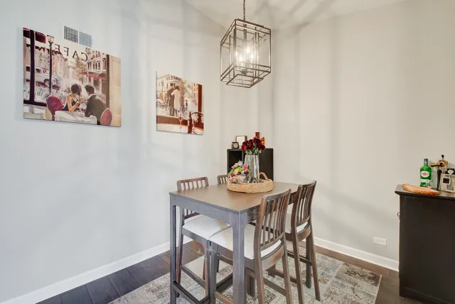 a dining room with furniture and chandelier