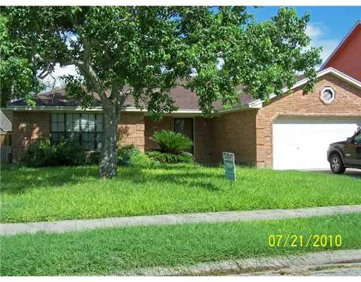 a front view of a house with a yard and a garage
