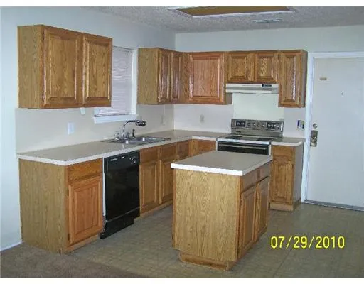 a kitchen that has a sink and a stove
