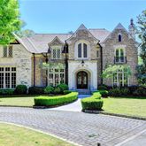 a front view of a house with yard and green space