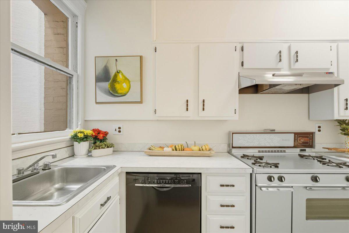2126 Connecticut Avenue Northwest, Unit 28 Washington, DC 20008 - Photo 11 of 34 a kitchen with a sink a stove and cabinets
