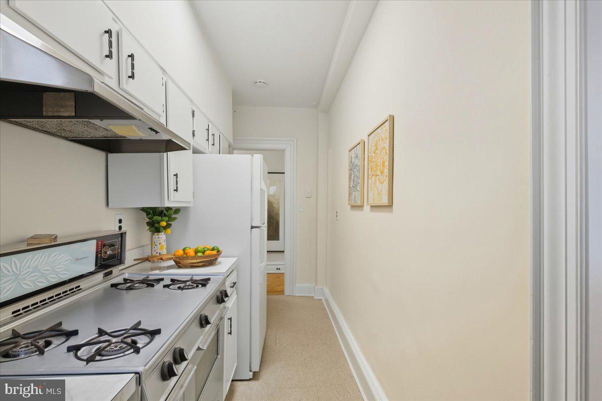 2126 Connecticut Avenue Northwest, Unit 28 Washington, DC 20008 - Photo 13 of 34 a kitchen with stainless steel appliances a stove a refrigerator and a refrigerator