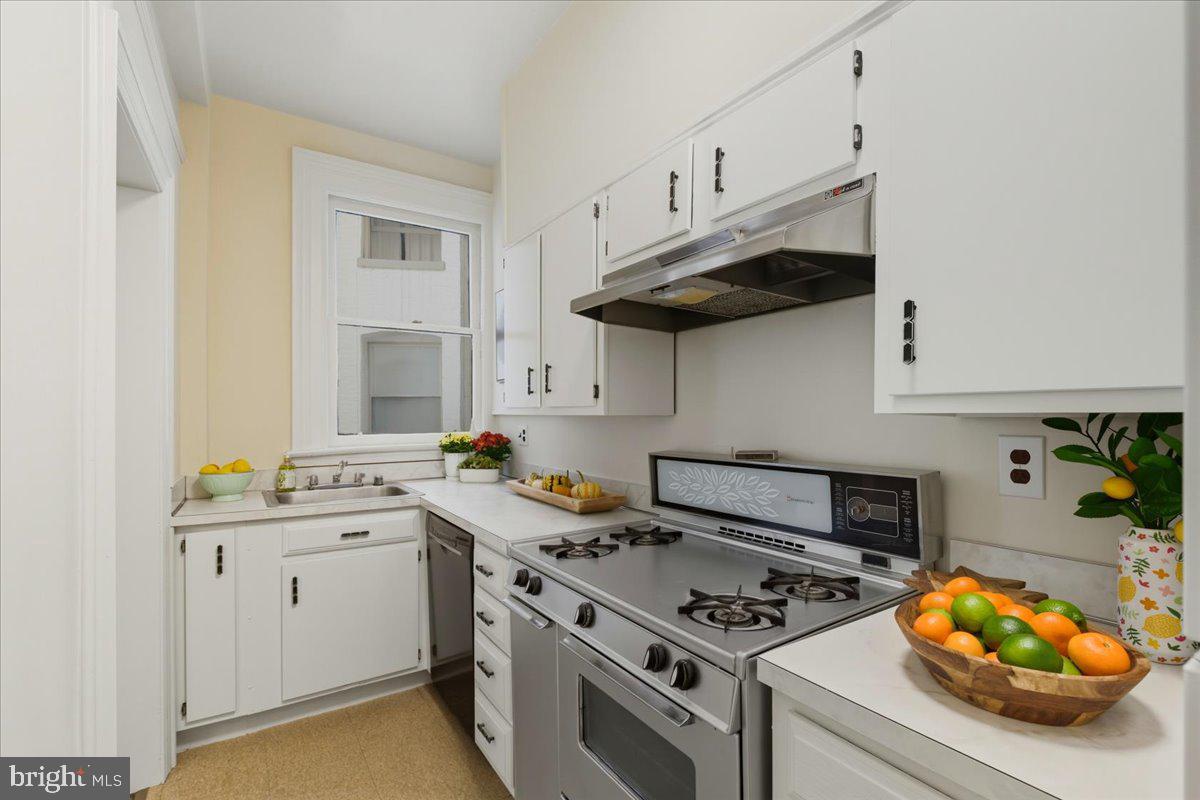 2126 Connecticut Avenue Northwest, Unit 28 Washington, DC 20008 - Photo 14 of 34 a kitchen with stainless steel appliances a stove a sink and cabinets