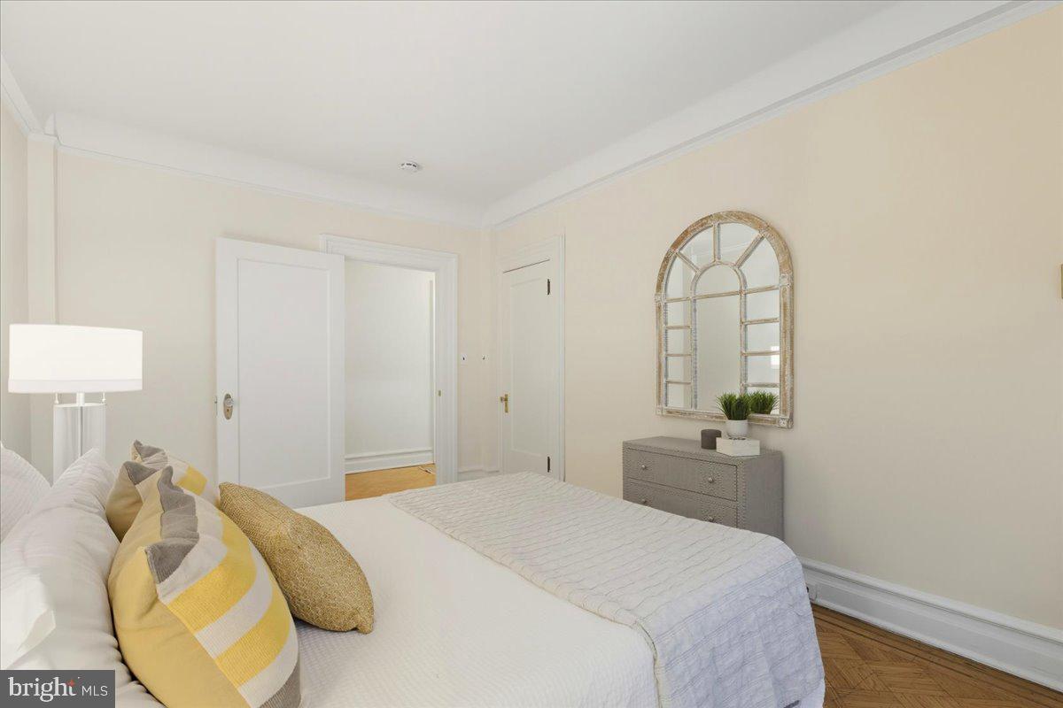 2126 Connecticut Avenue Northwest, Unit 28 Washington, DC 20008 - Photo 25 of 34 a bedroom with a bed and a chandelier