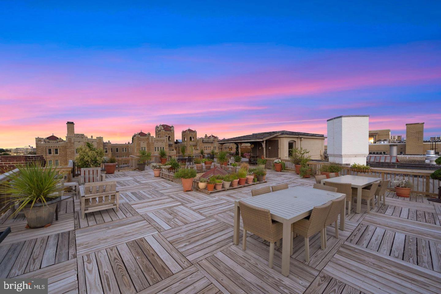 2126 Connecticut Avenue Northwest, Unit 28 Washington, DC 20008 - Photo 27 of 34 a view of a rooftop deck with lounge chairs and wooden floor