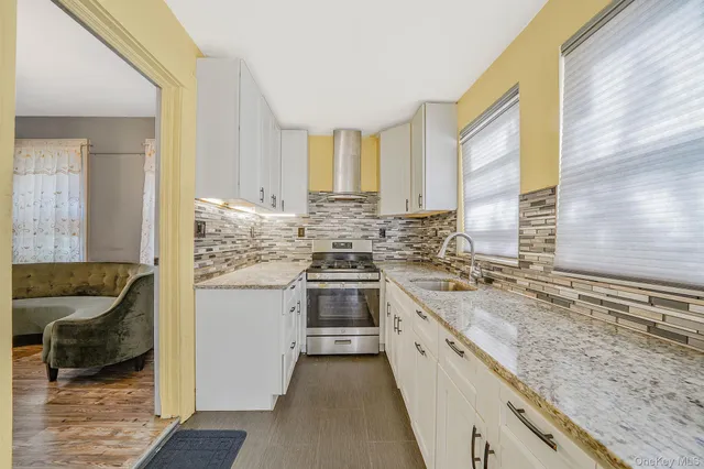 a kitchen with a sink stove and cabinets
