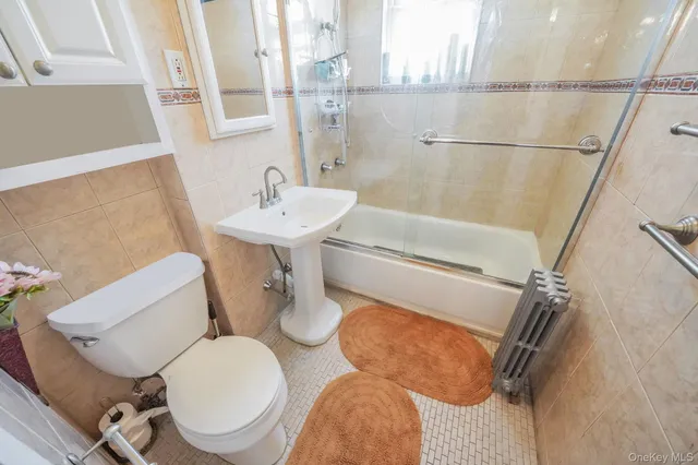 a bathroom with a sink mirror vanity and toilet
