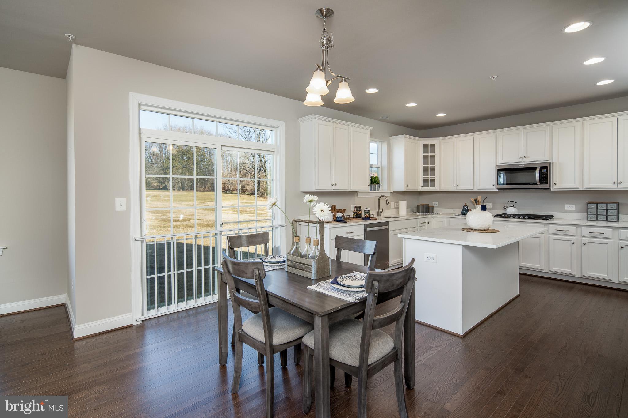 6444 Hanover Road Hanover, MD 21076 - Photo 12 of 29 a kitchen with kitchen island granite countertop a center island a sink cabinets and appliances