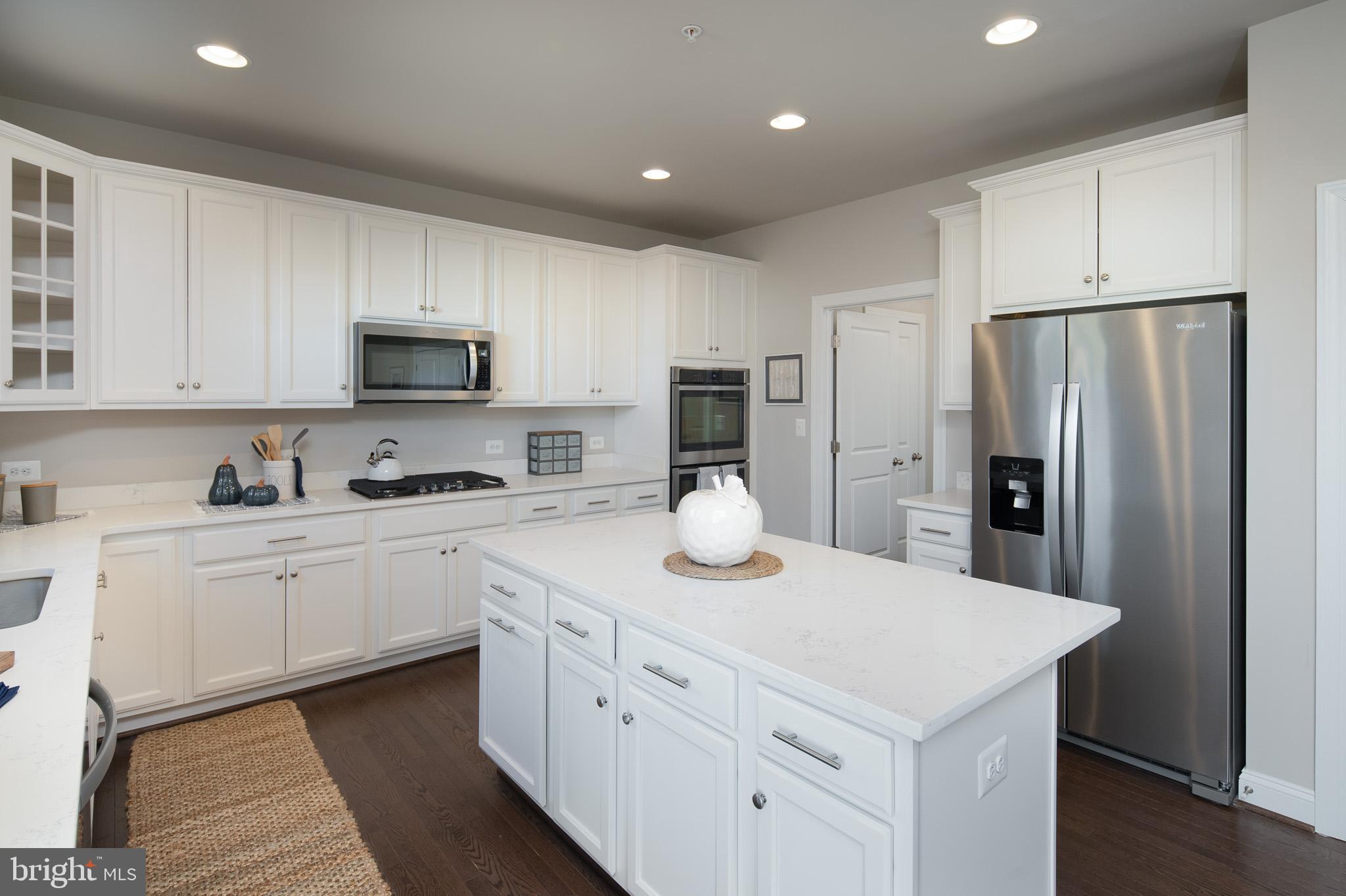 6444 Hanover Road Hanover, MD 21076 - Photo 3 of 29 a kitchen with white cabinets and stainless steel appliances