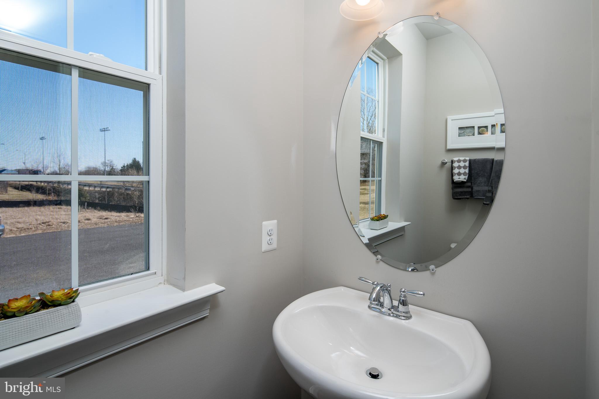 6444 Hanover Road Hanover, MD 21076 - Photo 22 of 29 a bathroom with a sink and a mirror